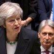 Theresa May battled to defend her draft Brexit deal before a hostile parliament