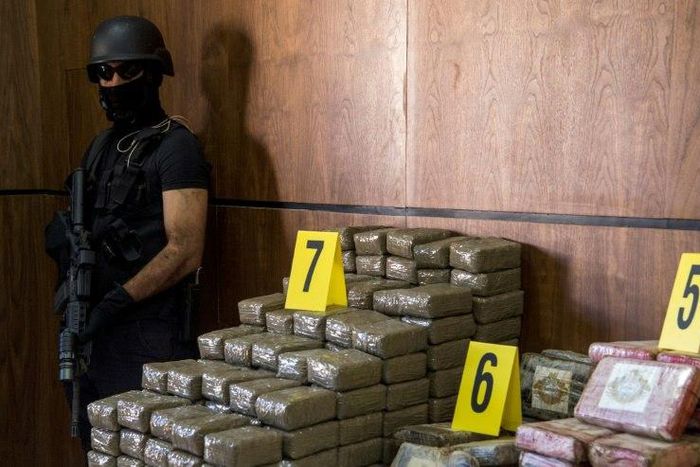A picture taken on October 4, 2017, shows seized drugs and weapons on display at the Central office of Criminal investigation in the Moroccan city of Marrakesh
