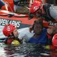 Members of the Spanish NGO Proactiva Open Arms rescue a woman in the Mediterranean sea in July 2018