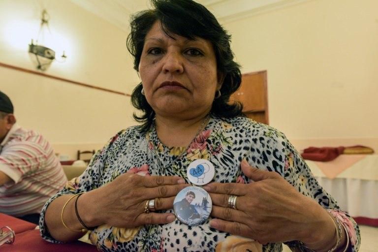 Yolanda Mendiola, mother of Argentine submariner Fabian Cisneros, shows a pin with his picture at a military hotel in Mar del Plata, Argentina, on November 07, 2018. Cisneros was part of the crew of the Argentine submarine San Juan, which went missing ...