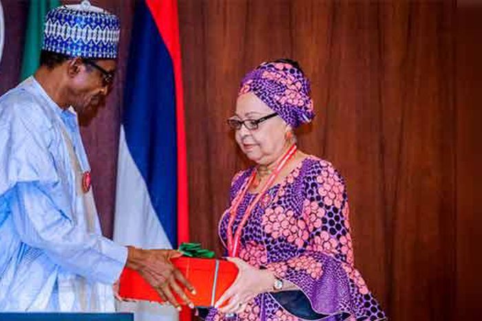 President Muhammdu Buhari receiving the report of the Tripartite Committee on the Review of National Minimum Wage from the Committee Chairman, Mrs Amal Pepple, at the State House on November 6, 2018.