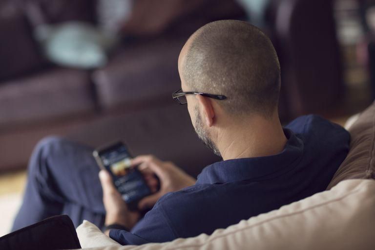 ___9068781___2018___11___4___15___man-sitting-on-a-sofa-whilst-browsing-on-a-royalty-free-image-860783572-1540926945