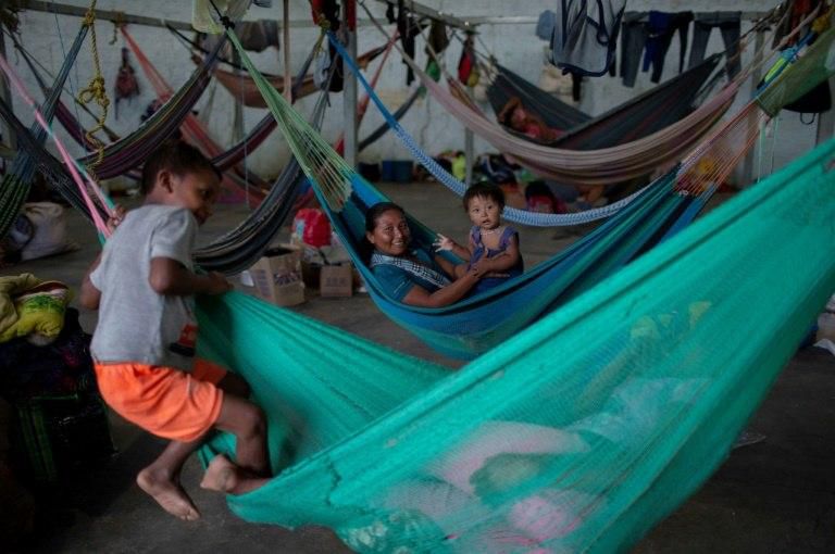 Members of the Warao tribe, Venezuela's second-largest indigenous group, rest in hammocks at a shelter where they have been taking refuge in the Brazilian border city of Pacaraima in August 2018 after a violent anti-migrant riot there