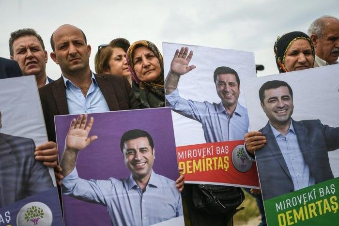Demirtas, seen here in posters held by his supporters, ran again for election in June 2018 from his prison cell