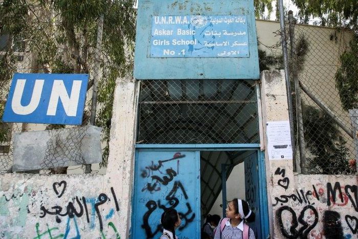 Palestinian girls outside a school run by UNRWA in the Askar refugee camp east of Nablus in the occupied West Bank on September 2, 2018
