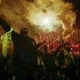 Demonstrators faced riot police on the Champs Elysees at the end of a protest by the French "yellow vests" (gilets jaunes) movement in central Paris on December 22