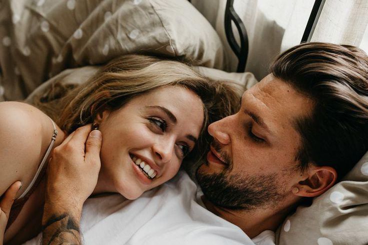 ___9125339___2018___11___21___8___high-angle-view-of-loving-young-couple-lying-on-bed-royalty-free-image-1032305820-1542739698