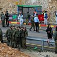 Israeli forces and forensic experts inspect the site of a gun attack at Asaf Junction in the West Bank on December 13, 2018