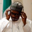 Nigeria's President Muhammadu Buhari adjusts his translation device during a news conference at the presidential villa in Abuja, Nigeria, August 31, 2018.