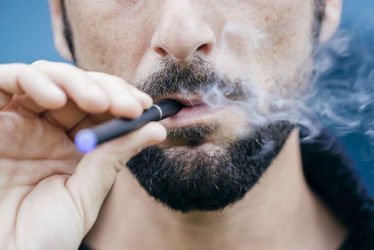 ___9178489___2018___12___7___18___portrait-of-man-smoking-an-electronic-cigarette-royalty-free-image-702543303-1544124082