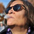 Anne Genovy smokes marijuana in Vancouver, Canada, as nearly a century of marijuana prohibition came to an end