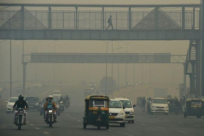 Commuters donned masks in New Delhi as visibility on major roads was reduced to barely 50 metres the morning after Diwali celebrations