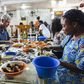 Anthony Bourdain and Nigerian food bloggers eating Pounded Yam and Egusi