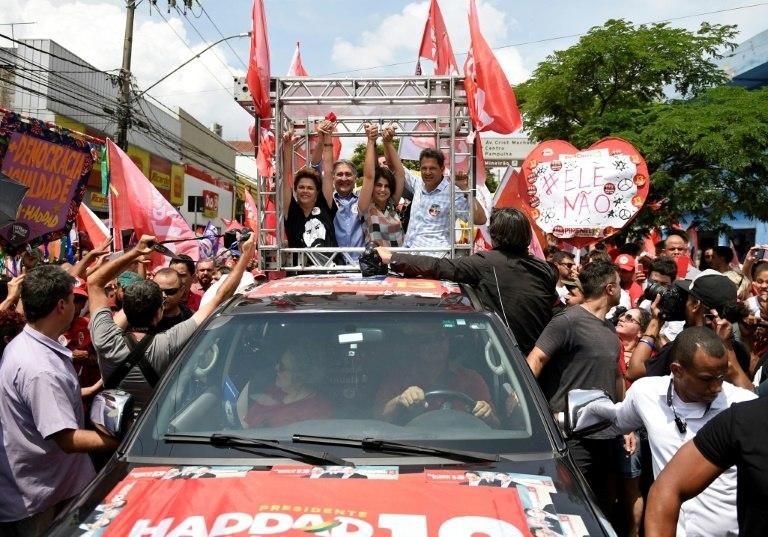 Brazilian presidential candidate Fernando Haddad (R), who sells himself as "Lula's candidate," rallied with his running mate Manuela d'Avila (2-R), the Governor of Minas Gerais Fernando Pimentel (2-L) and former president Dilma Rousseff (L)