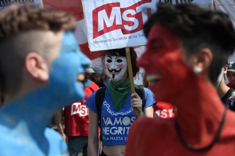 A woman with a Guy Fawkes mask protests as the G20 summit takes place
