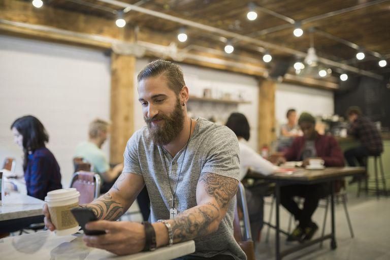 ___9171780___2018___12___5___22___bearded-man-with-tattoos-drinking-coffee-in-cafe-royalty-free-image-554995557-1544034985