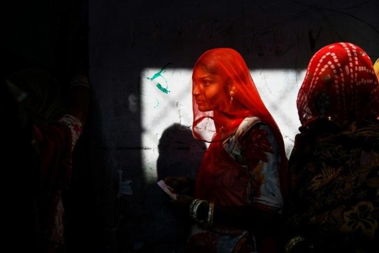 Women queue to vote in the Rajasthan ballot which is is seen as a key test for Prime Minister Narendra Modi ahead of general elections next year