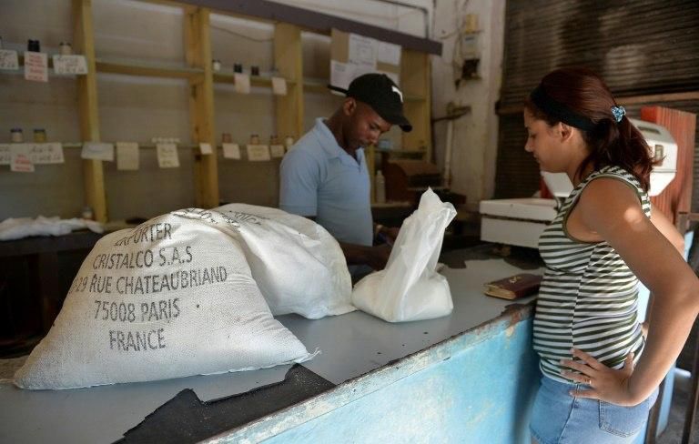 A woman buys sugar produced in France at a grocery store in the Cuban capital Havana -- experts are hoping the sector can rebound on the island, possibly with some foreign investment