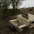 A military Humvee can be seen mired in the mud on the banks of the Rio Grande