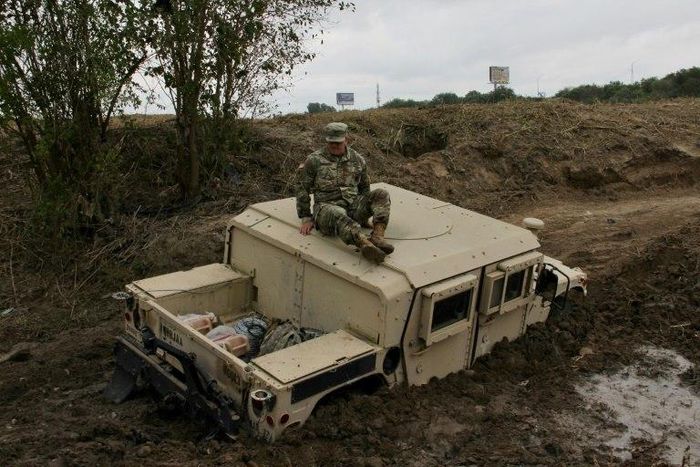A military Humvee can be seen mired in the mud on the banks of the Rio Grande