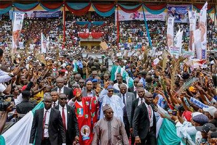 President Buhari greeting APC supporters at the campaign rally in Ekiti