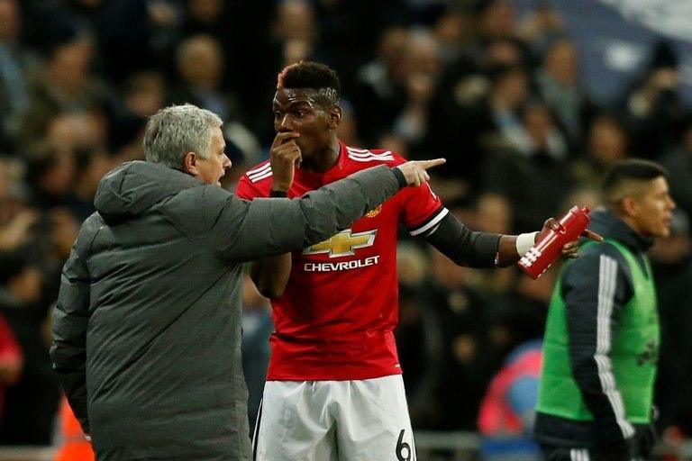 Manchester United's manager Jose Mourinho (L) talks with midfielder Paul Pogba (R) after the second Tottenham goal goes in during the English Premier League football match against Tottenham Hotspur January 31, 2018