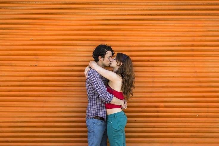 ___8918187___2018___9___29___20___romantic-couple-kissing-in-front-of-orange-shutter-royalty-free-image-501884093-1537805601