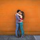 ___8918187___2018___9___29___20___romantic-couple-kissing-in-front-of-orange-shutter-royalty-free-image-501884093-1537805601