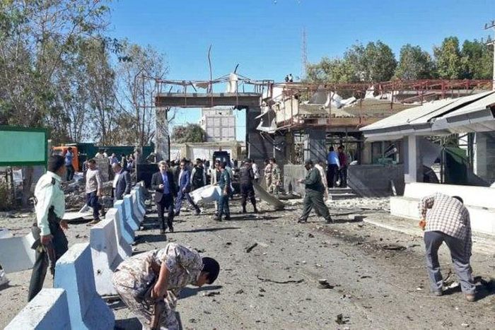 Iranian police survey the aftermath of a suicide car bombing which killed at least two people and wounded many more outside police headquarters in the southeastern port city of Chabahar