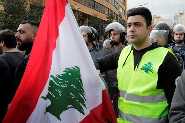 A Lebanese protester wears a yellow vest, inspired by France's Gilet Jaunes, during an anti-corruption demonstration in Beirut on December 23, 2018