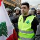 A Lebanese protester wears a yellow vest, inspired by France's Gilet Jaunes, during an anti-corruption demonstration in Beirut on December 23, 2018