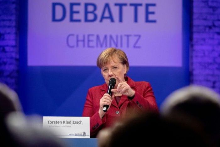 Merkel spent half a day in the former communist city of Chemnitz meeting residents, but tensions were clear with about one hundred far-right protesters marching and the city mayor criticizing her