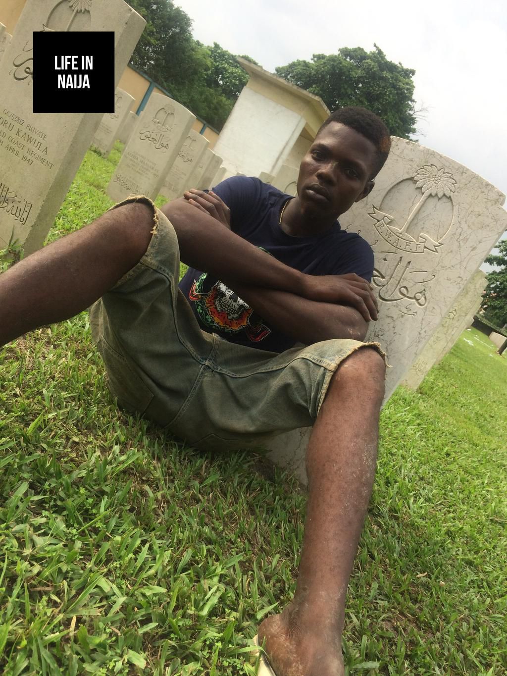 Toheeb is not a direct employee at the cemetery where he works. He gets money by working for a boss who takes orders from his father who is charged by the United Nations Organization to keep a War Memorial in good condition.
