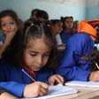 Syrian students attend classes at a regime-held school in the centre of the multi-ethnic city of Qamishli