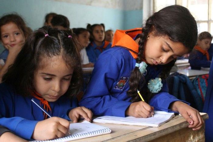 Syrian students attend classes at a regime-held school in the centre of the multi-ethnic city of Qamishli