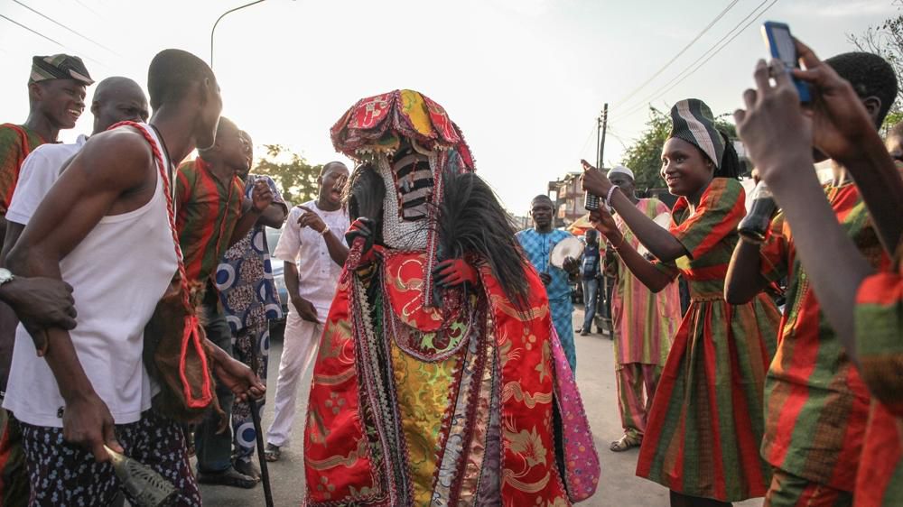People celebrating the Egungun masquerade [Al jazeera]