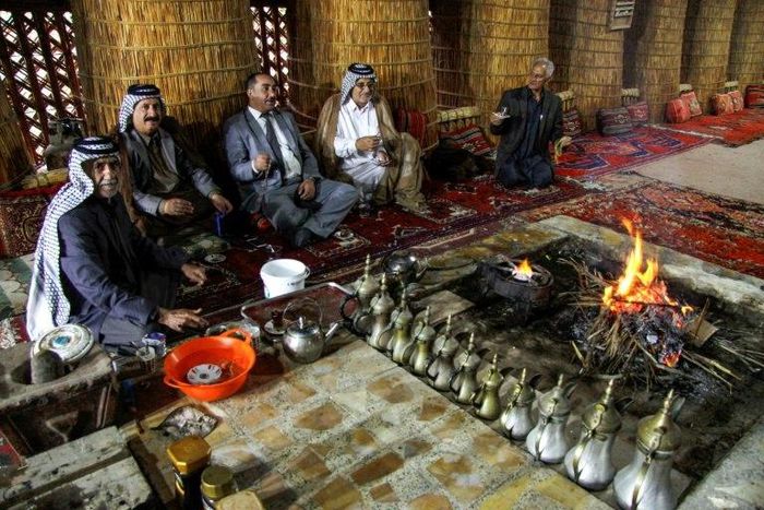 Members of an Iraqi clan gather inside a straw tent in the town of Mishkhab, south of Najaf on November 15, 2018