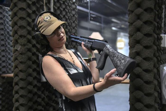 Brazilian lawyer Barbara Barroso proudly shows off her brand-new 12-gauge Armsan pump-action shotgun at the Colt 45 Shooting Club in Rio de Janeiro