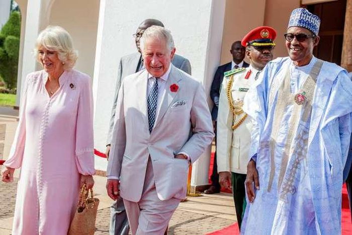 Prince Charles (M) and his wife Camilla, the Duchess of Cornwall (L) and President Buhari (R)