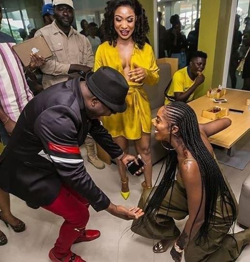 Tiwa Savage knees down to greet Sir Shina Peters