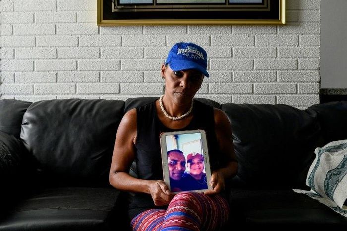 Yamileth Marcano shows a picture of her brother who was stabbed to death for his smartphone, becoming one of the thousands murdered in crisis-hit Venezuela