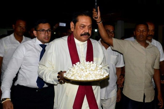 The crisis was sparked by the president sacking the prime minister and naming former strongman leader Mahinda Rajapakse (C) in his place