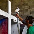 An inmate of La Joya prison in Panama works on painting a cross that will be used during Pope Francis's visit to Panama for World Youth Day celebrations in January