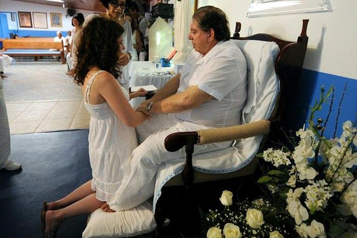 Several women have accused Brazilian 'spiritual healer' Joao Teixeira de Faria, or 'Joao of God,' of sexually abusing them under pretext of helping cure them of various problems; he is seen here with a patient in a 2012 file photo taken in the city of ...