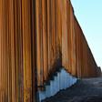 A guard stands watch at the wall along the US-Mexico border