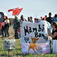 A banner reads "Hambi for Bambi" as thousands of demonstrators gather to celebrate the suspension of the planned razing of the forest in what they dubbed the region's "biggest-ever anti-coal rally"