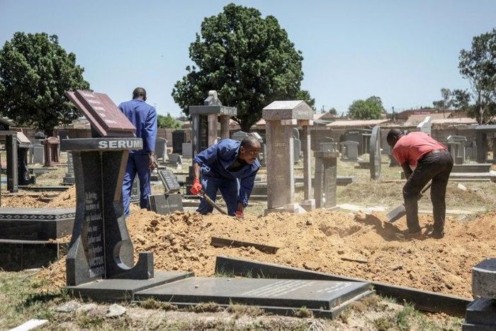 Gravediggers in Johannesburg, where between 45 and 60 graves are re-opened each week on average to allow for second burials