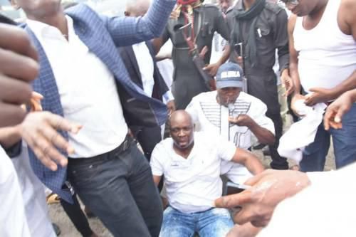 Governor Fayose on the ground after he was allegedly attacked by policemen