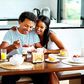 A happy young couple enjoying breakfast in their home.
