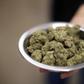 A woman holds marijuana for sale at the MedMen store in West Hollywood